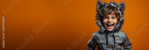 Child in the cute costume of a werewolf isolated on a vivid background with a place for text 