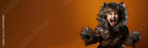 Child in the cute costume of a werewolf isolated on a vivid background with a place for text  © fotogurmespb