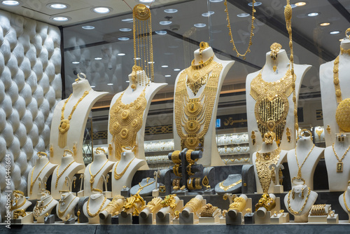 Showcase of a jewellery store with many golden items on display. Deira gold souk market, Dubai, UAE.