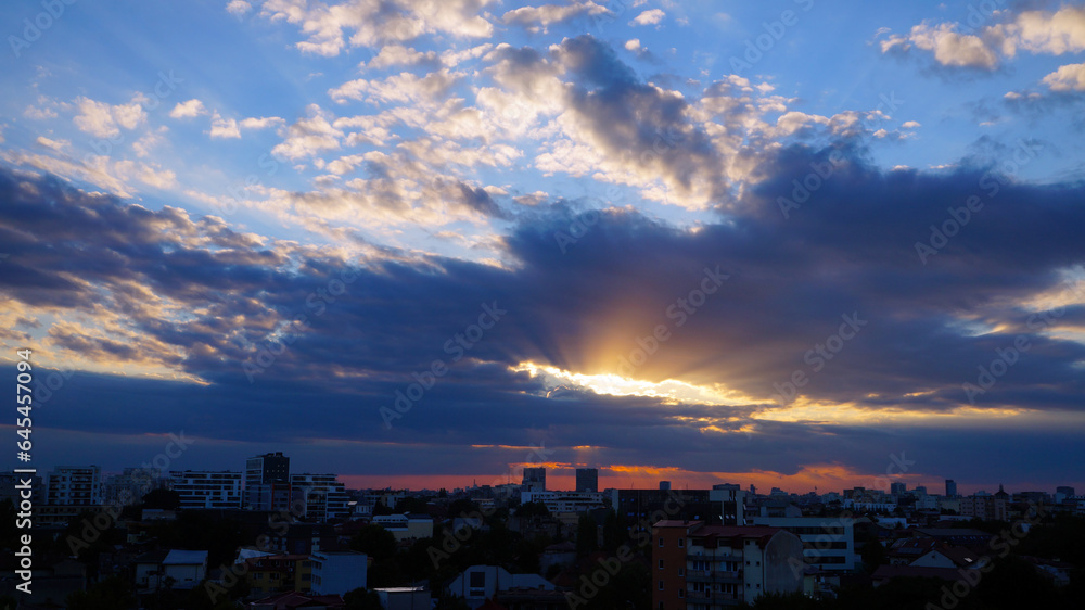 Bucharest skyline at sunset, sunrise sky with clouds. Purple sunset over Bucharest city