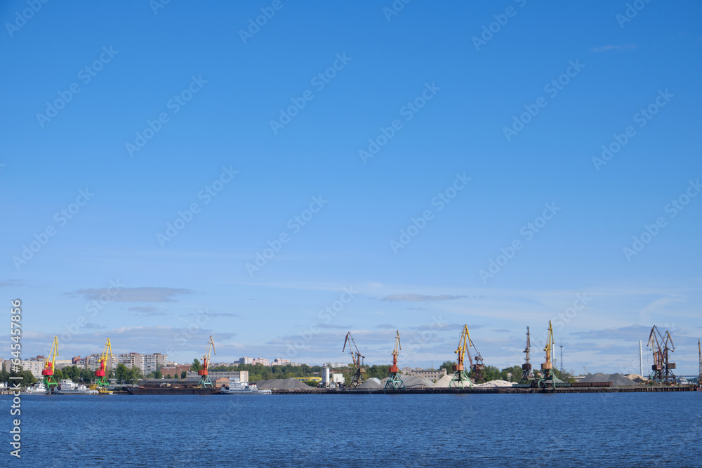 Landscape with a view of the river and the port, cranes
