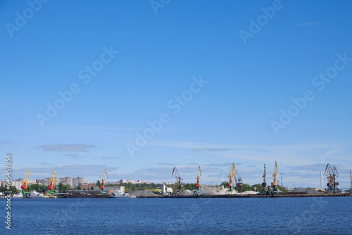 Landscape with a view of the river and the port, cranes © grek881