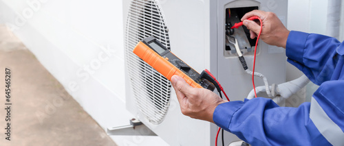 Fotografie Air conditioner technician checking air conditioner operation