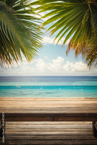 Wood Table with Seaside View, Palm Leaves, and Calm Sea Blur Bokeh - A Perfect Background for Your Product Display or Summer Vacation Concept. © @uniturehd