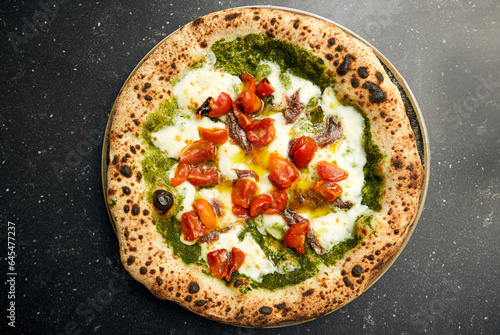 Pizza Perfection: Pesto, Mozzarella, and Tomato Delight on Black Marble