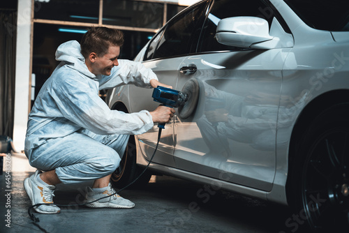 Automotive repair shop, concept of car detailing and polishing by professional car service worker with precision using orbital polisher machine creative captivating automotive flourish . Oxus photo