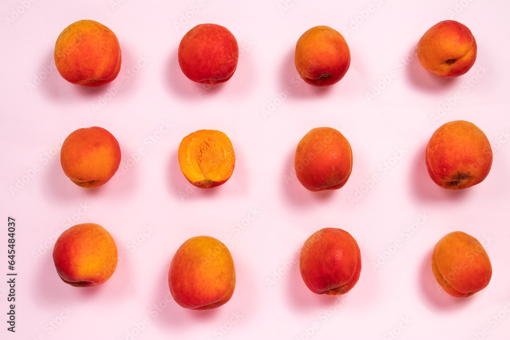 Fresh ripe apricots pattern on a pink background
Fresh ripe apricots pattern on a pink background