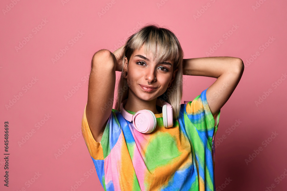 Smiling female hipster with headphones around neck Smiling female hipster with headphones around neck