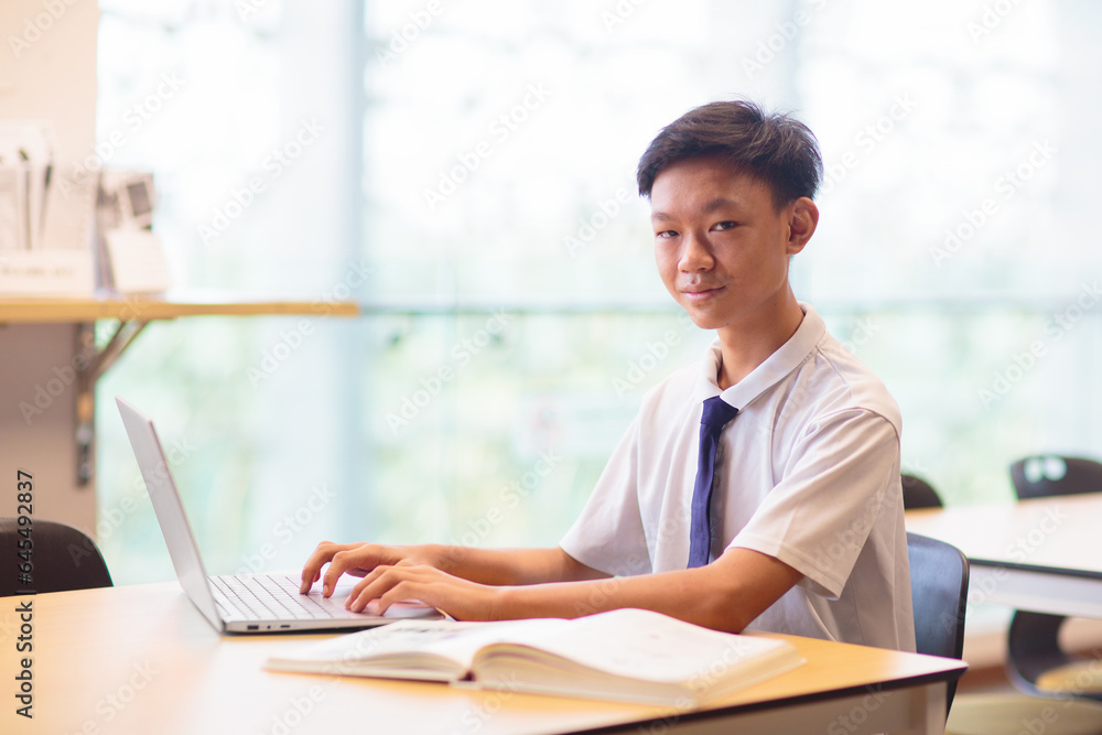 Asian boy in school. Student in classroom.
