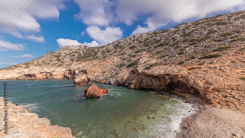 An abandoned rusty ship in the sea timelapse near huge rock formations in Navagio Beach, Amorgos Island, Greece