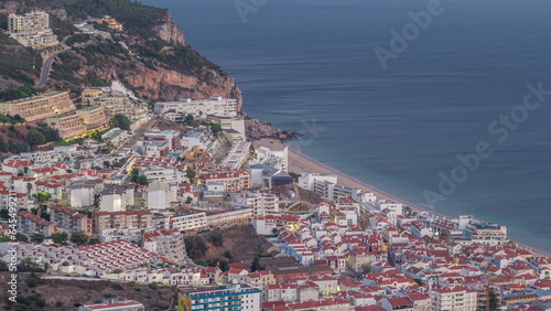 Aerial view of the coastline of the village of Sesimbra day to night timelapse. Portugal