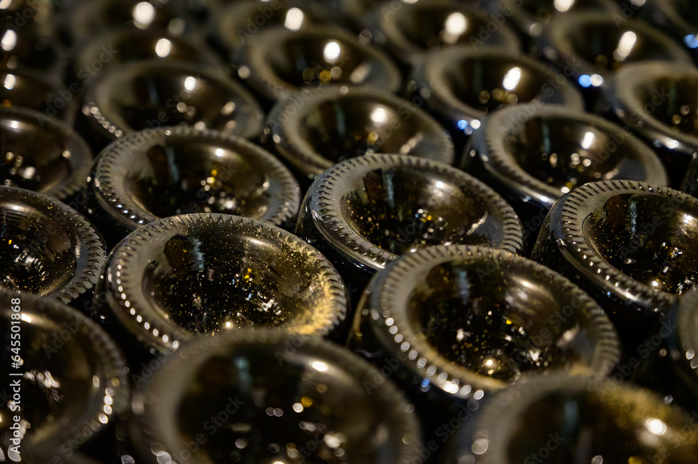 Many bottles of champagne sparkling wine. Visit of undergrounds caves, traditional producing of champagne wine in Cote des Bar, Aube, south of Champagne, France Many bottles of champagne sparkling wine. Visit of undergrounds caves, traditional producing of champagne wine in Cote des Bar, Aube, south of Champagne, France