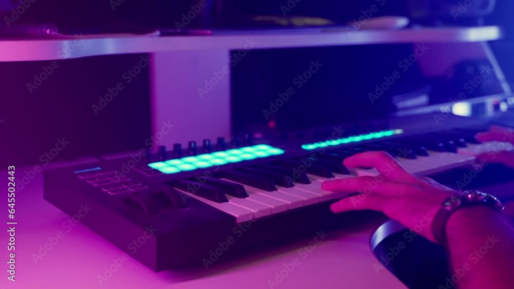 composer man is playing keyboard in modern digital audio workstation, closeup view of hand composer man is playing keyboard in modern digital audio workstation, closeup view of hand