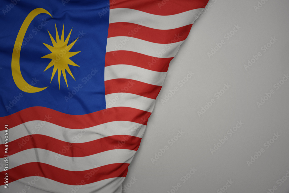 Obraz premium big waving national colorful flag of malaysia on the gray background.