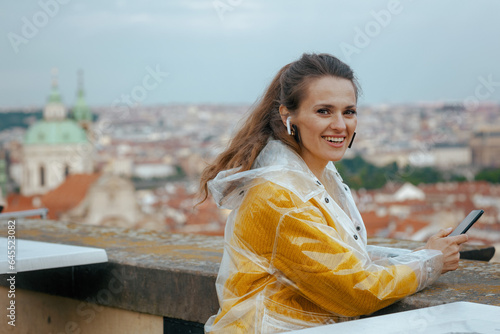Photography happy stylish woman in Prague Czech Republic using phone