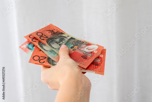 Woman holding Australian Currency - Twenty Dollars of Australia Banknotes photo