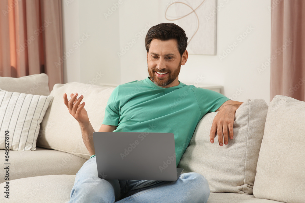 Man having video chat via laptop at home Man having video chat via laptop at home