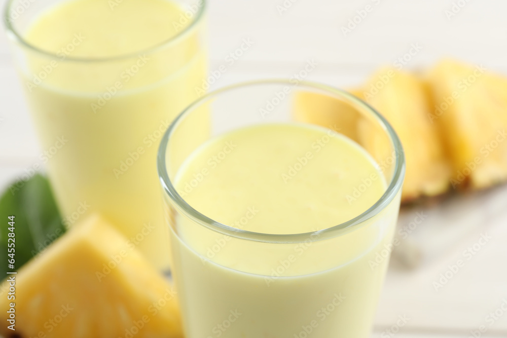 Tasty fresh pineapple smoothie on table, closeup Tasty fresh pineapple smoothie on table, closeup