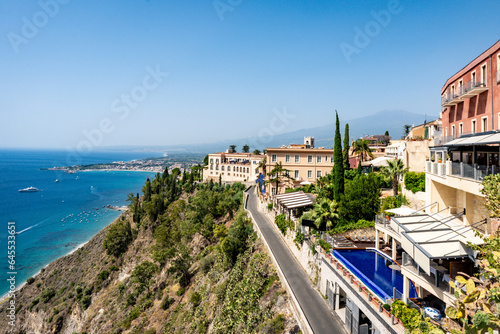 Hotel building in Taormina with accommodation for tourists on a hill
