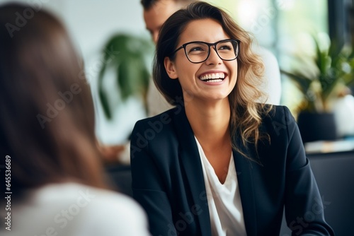 Generative AI : Happy young businesswoman coach mentor leader laughing at funny joke at group business meeting, joyful smiling millennial lady having fun with diverse corporate team people engaged in 