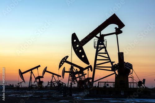 In the evening, oil pumps are running, Silhouette of beam pumping unit