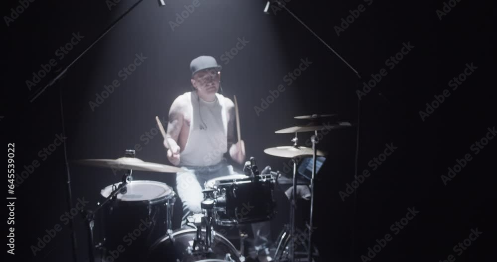 Skilled drummer playing ride and crash cymbals on stage Skilled drummer playing ride and crash cymbals on stage