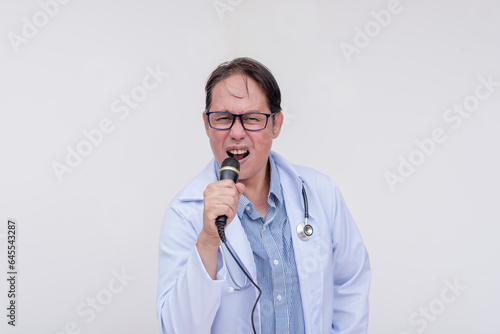 A family doctor singing with a microphone during a karaoke session after work. Of asian descent, middle aged male in his 40s. Isolated on a white background.