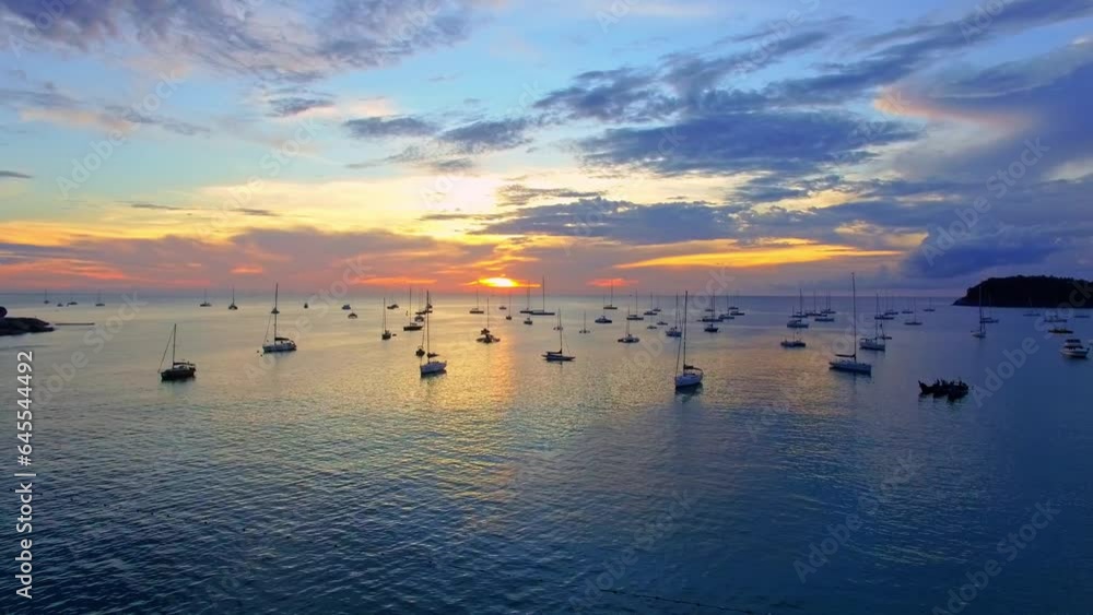 .every year on the first week of December they have yacht king cup racing in Phuket..Kata beach is the marina of yachts..Yachts in the marina background.Beautiful sunset over the yachts.. .every year on the first week of December they have yacht king cup racing in Phuket..Kata beach is the marina of yachts..Yachts in the marina background.Beautiful sunset over the yachts..