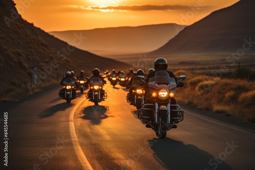 group of motorcycle riders riding together at sunset