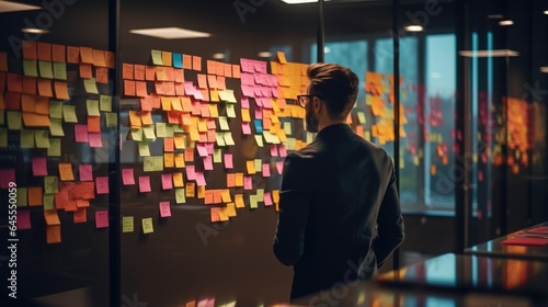 Web designer is working with brainstorming board full of sticky note from colleague. business teamwork concept picture.