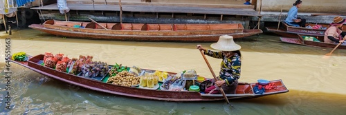 Photography market stall holders in small boats selling local fruits and vegetables, Damnoen