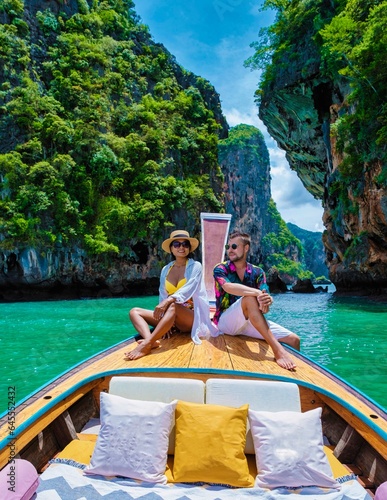 Luxury Longtail boat in Krabi Thailand, couple man, and woman on a trip at the tropical island 4 Island trip in Krabi Thailand. Asian woman and European man mid age on vacation in Thailand. © Fokke Baarssen