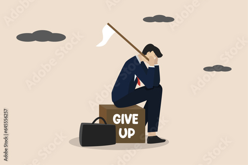 Giving up, business failure, failed businessman, work mistakes or failure business concept, quitting work or giving up, businessman sitting depressed holding white flag giving up sign.  photo