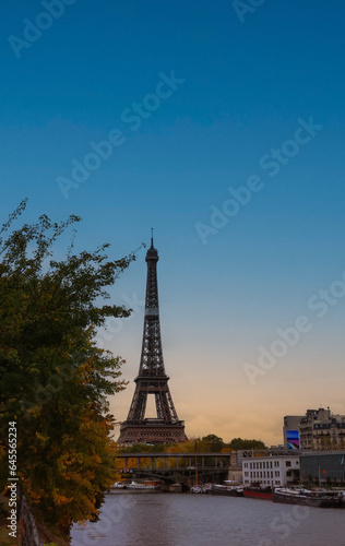Banner of travel in Paris with Eiffel Tower iconic Paris landmark across the River Seine with  tourist boat in  Autumn tree fall scene at Paris  France