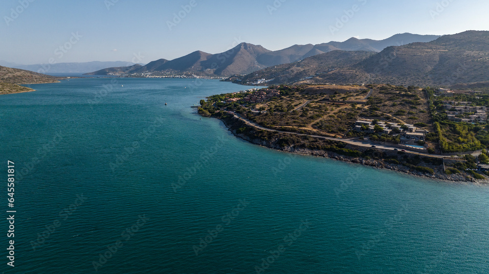 panoramic view of the sea bay with boats and ancient buildings on the island of Crete filmed from a drone