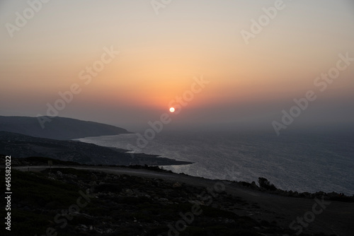 Sunset at the end of the day against the backdrop of the sea on the island of Crete