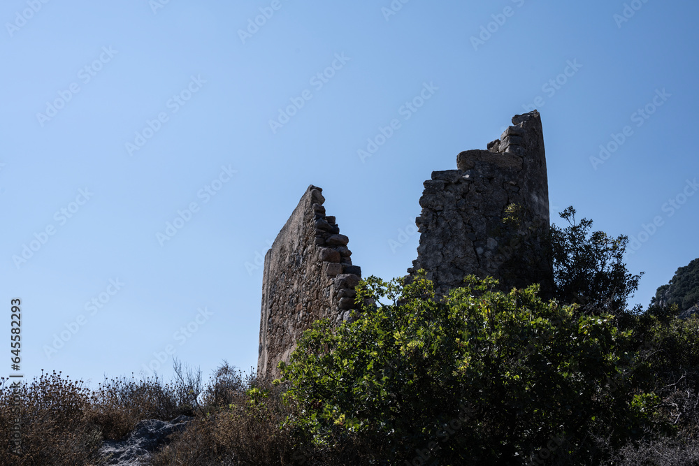 Old houses and ruins and stone churches with a sunny summer day on Crete Island