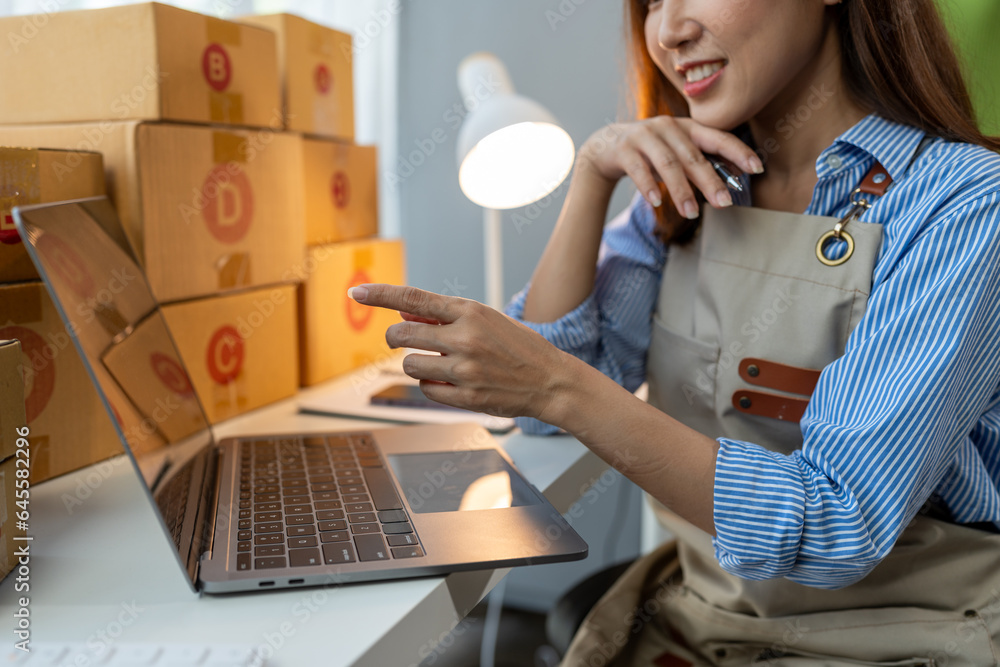 Small business start-up, SME owner, female entrepreneur working on packaging parcels. Receipt and check orders online to prepare boxes for sale to customers, online SME business concept. Small business start-up, SME owner, female entrepreneur working on packaging parcels. Receipt and check orders online to prepare boxes for sale to customers, online SME business concept.