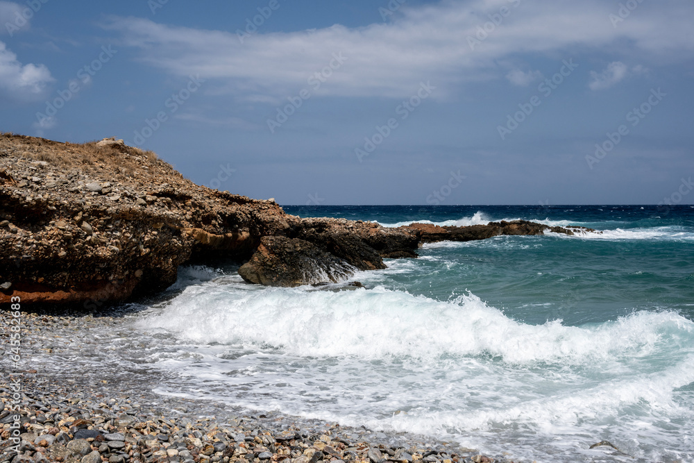The turbulent sea with a sunny summer day on the island of Crete
