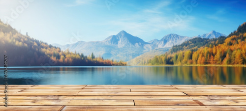 Empty wooden table rustic in front of Beautiful autumn mountain nature lake with blue sky background in the background with copy space, blank for text ads, and graphic design.