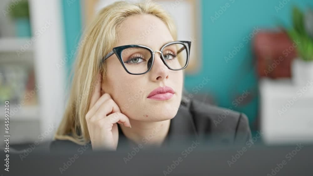 Young blonde woman business worker using computer thinking at the office Young blonde woman business worker using computer thinking at the office