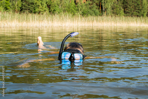 Weekends in nature with family, child in underwater diving mask