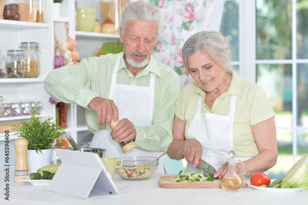 senior couple making salad together at kitchen senior couple making salad together at kitchen