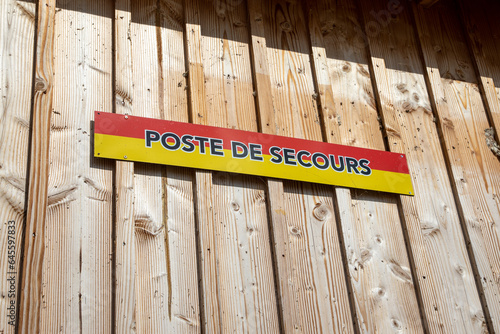 poste de secours french text means Lifeguard on wall facade wooden cabin hut on Beach