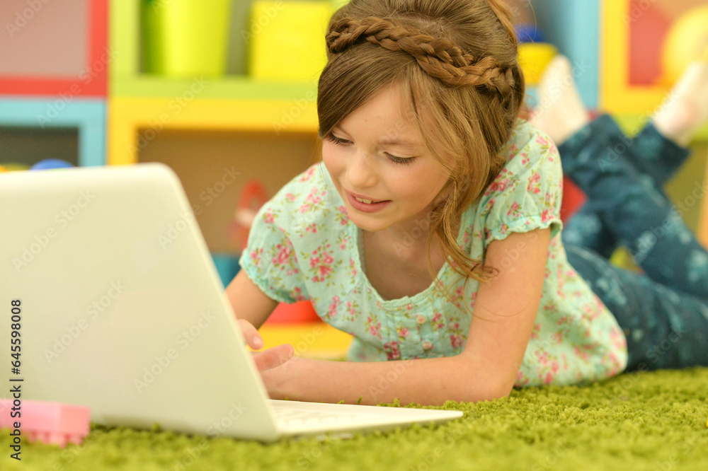 Cute and happy little girl children using laptop computer Cute and happy little girl children using laptop computer