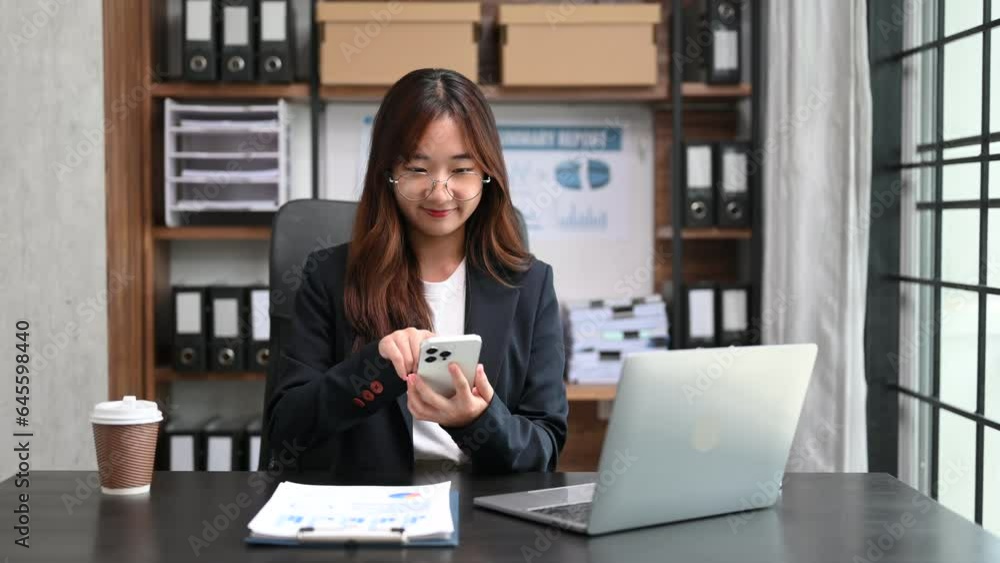 Young beautiful woman typing on tablet and laptop while sitting at the working white table office. Young beautiful woman typing on tablet and laptop while sitting at the working white table office.