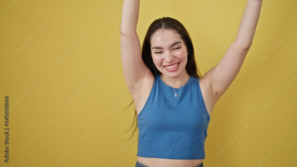 Young beautiful hispanic woman smiling confident shouting over isolated yellow background Young beautiful hispanic woman smiling confident shouting over isolated yellow background