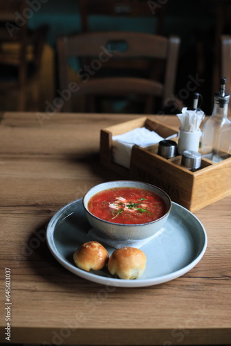 Traditional Ukrainian Russian borscht . Bowl of red beet root soup borsch with white cream . Beet Root delicious soup . Traditional Ukraine food cuisine