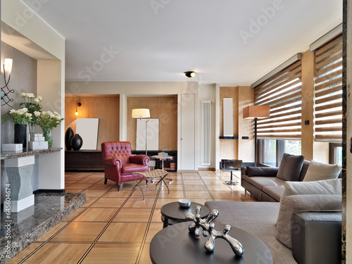interior of a modern living room with wooden floor and leather armchair and fabric sofa (ID: 645604674)