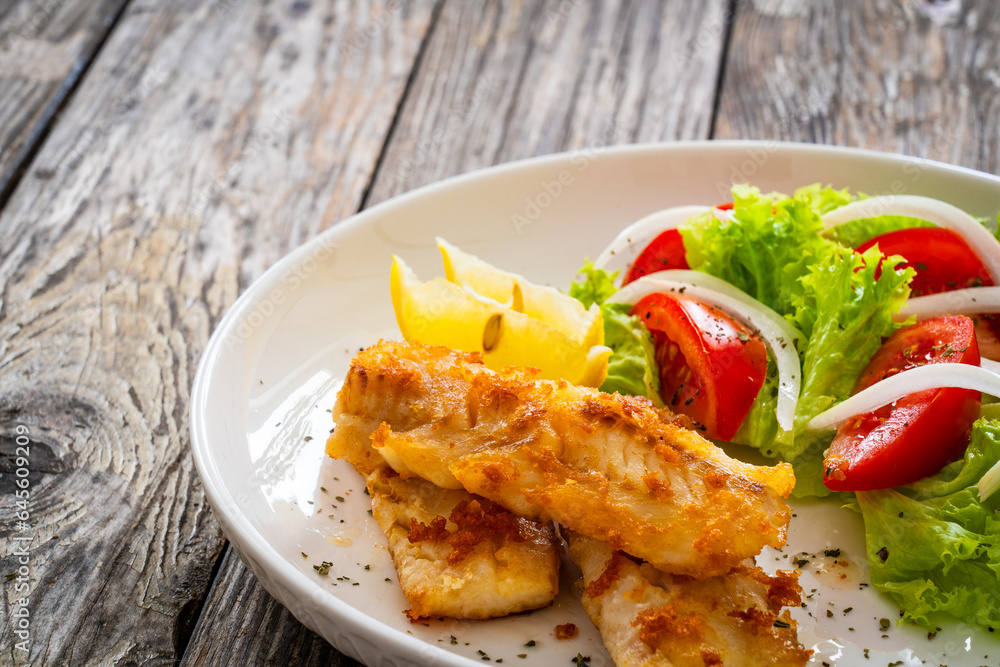 Seared cod loin and fresh vegetables on wooden table
Seared cod loin and fresh vegetables on wooden table